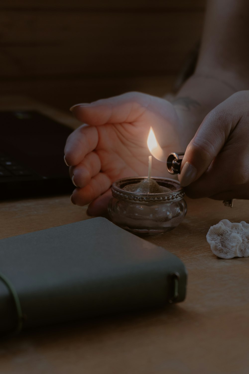 a person lighting a candle on a table