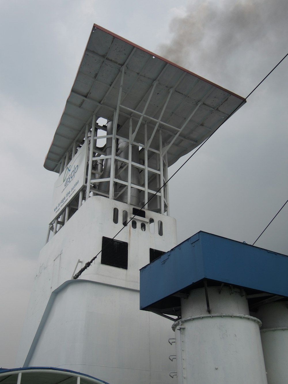 smoke billows from the top of a ship