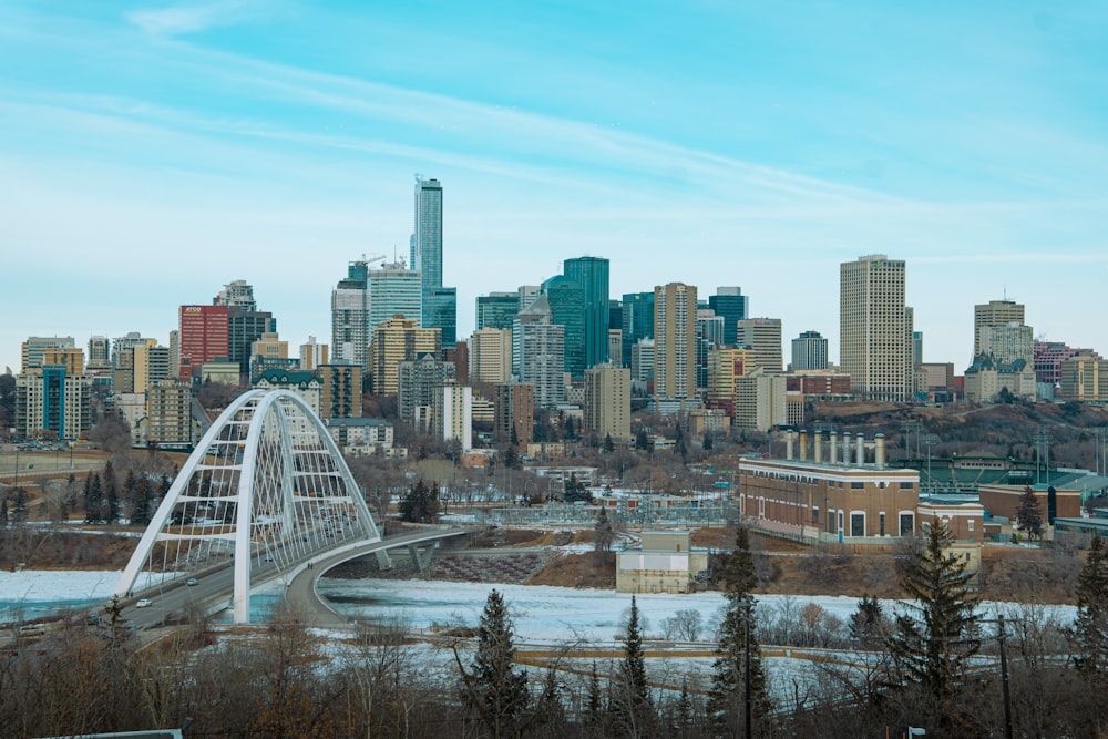 a city skyline with a bridge in the foreground