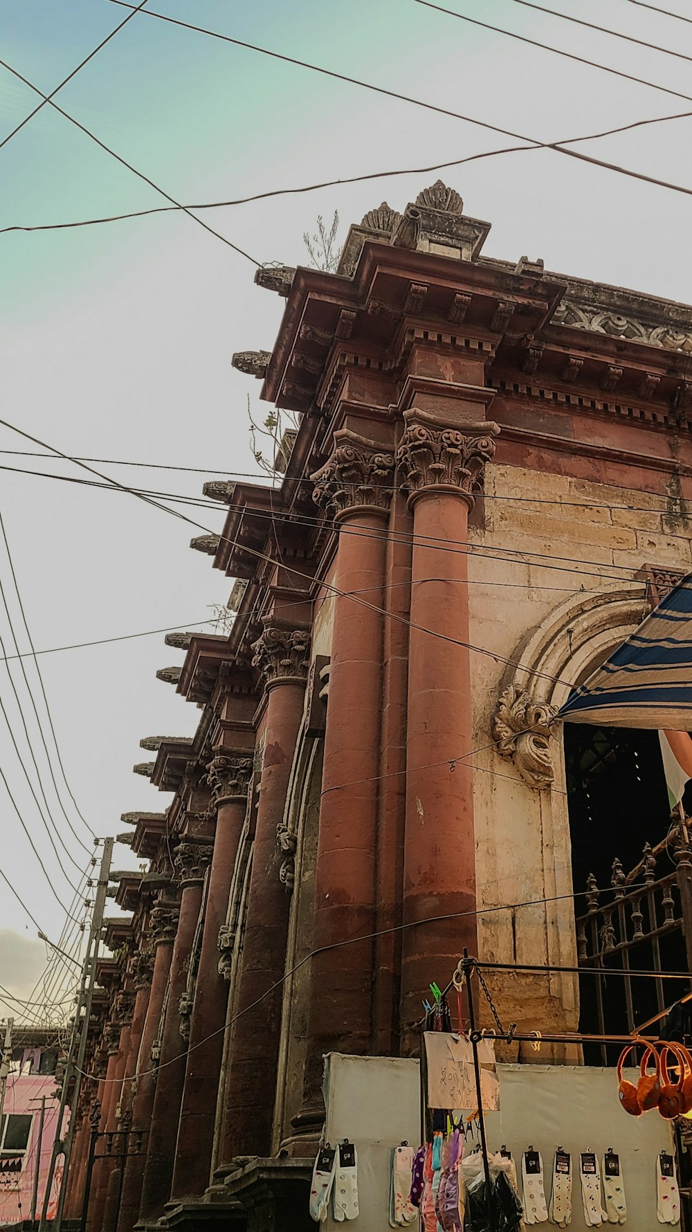 an old building with a lot of wires above it