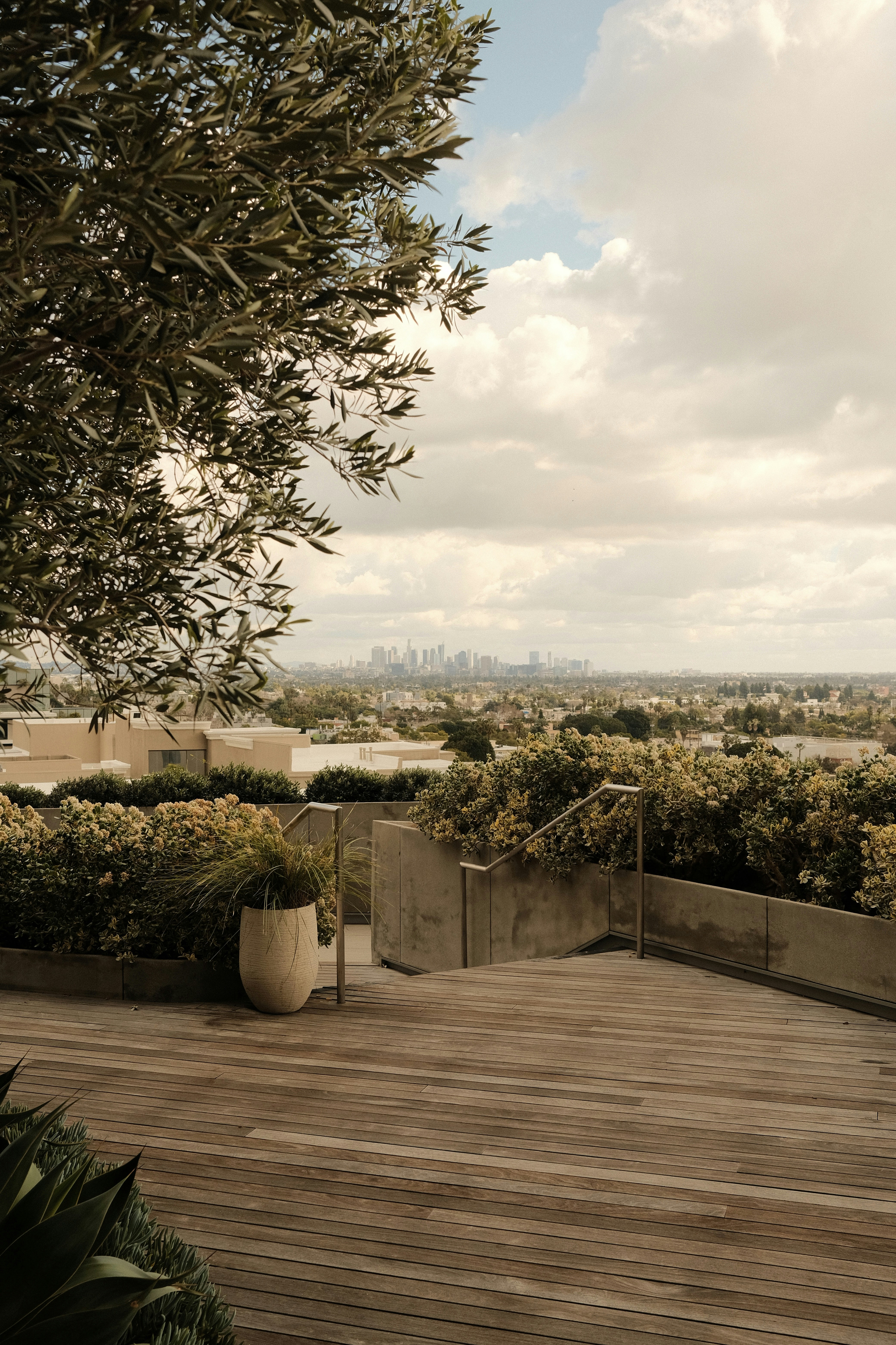 a wooden deck with a planter on top of it