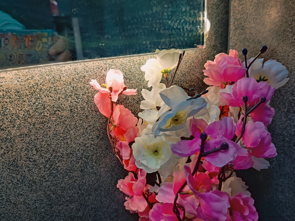 a bunch of flowers that are sitting on the ground