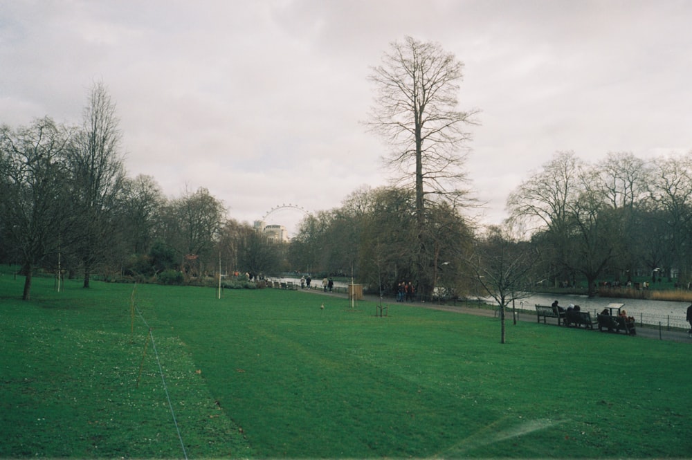 a group of people sitting on a bench in a park