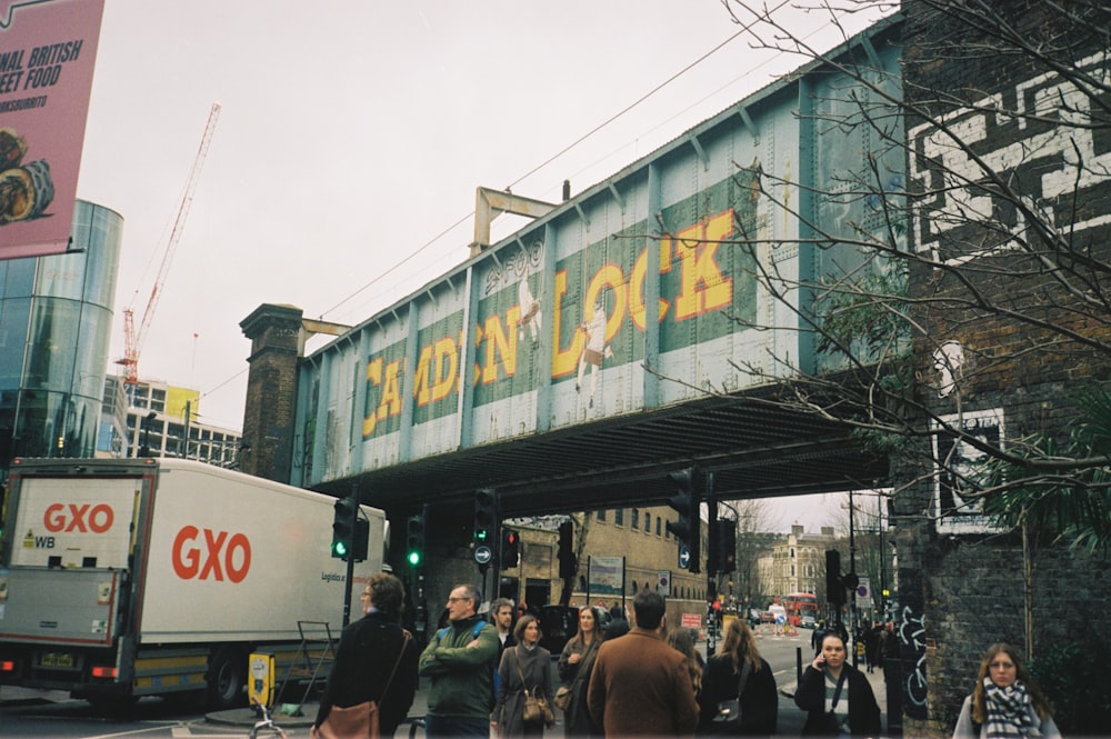 a group of people walking under a bridge