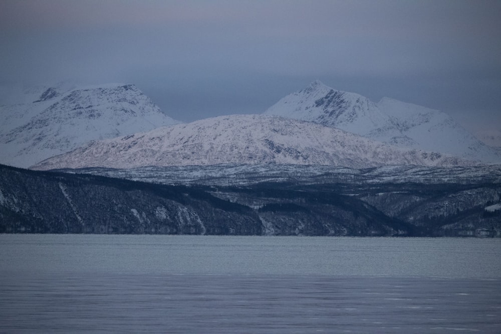 a large body of water with mountains in the background