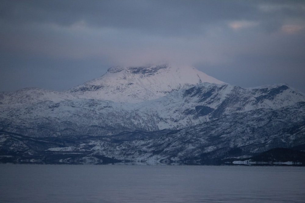 a mountain covered in snow on a cloudy day