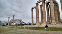 a man standing in front of some ancient ruins