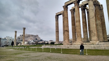 a man standing in front of some ancient ruins