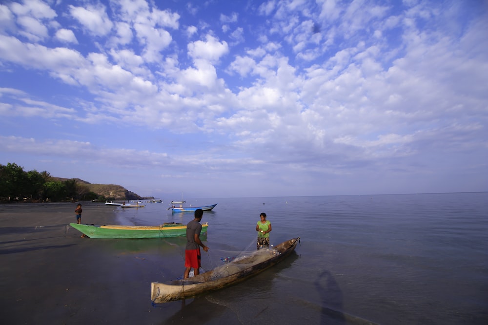 a group of people standing on top of a wooden boat