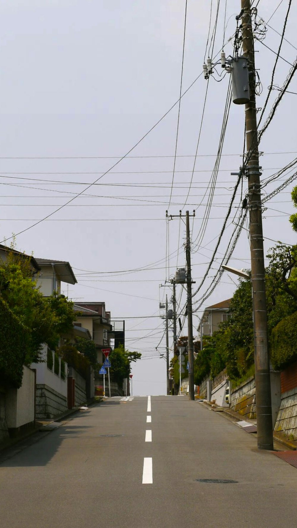 an empty street with power lines above it