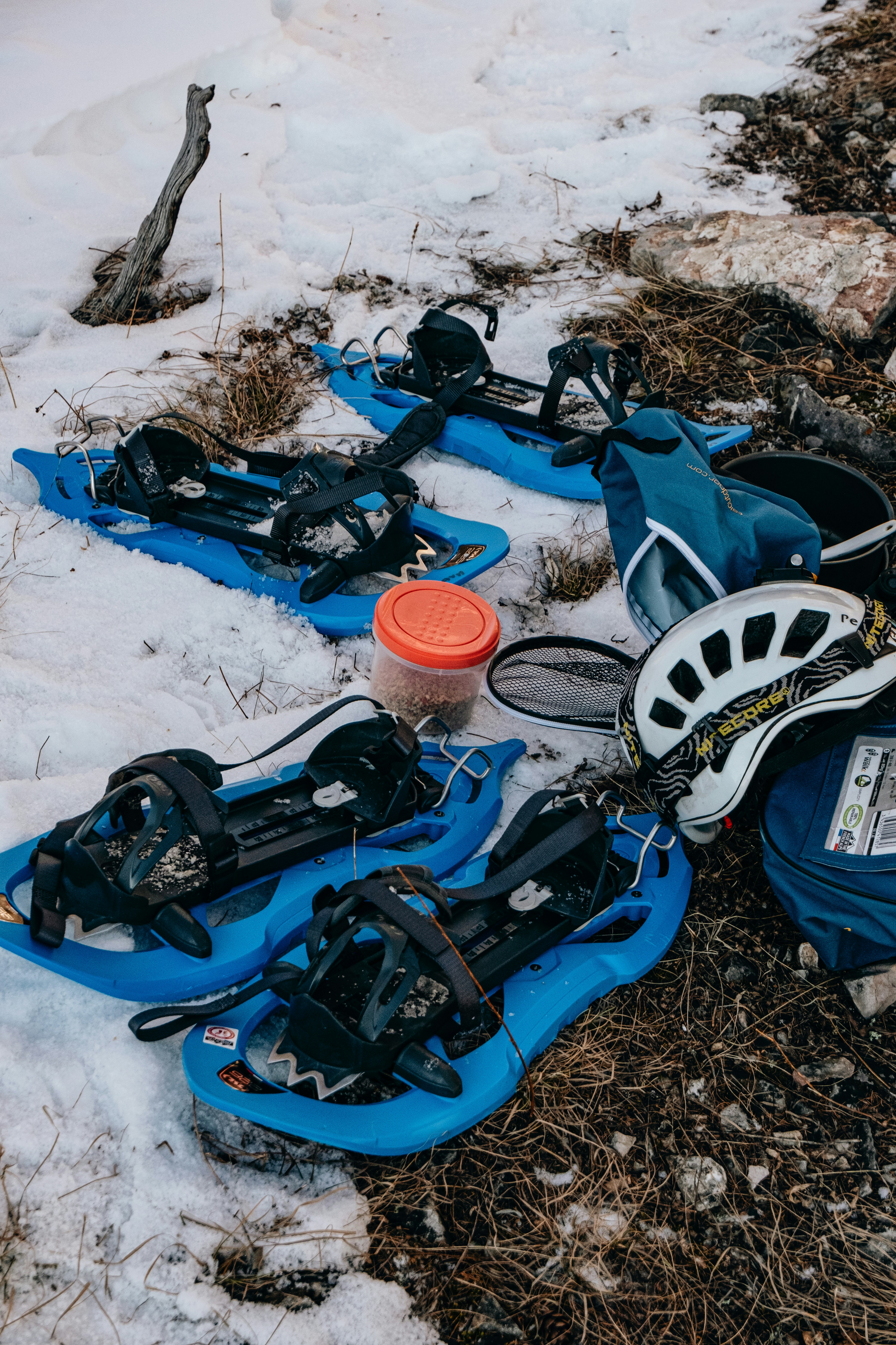 a couple of blue snow boards sitting on top of snow covered ground