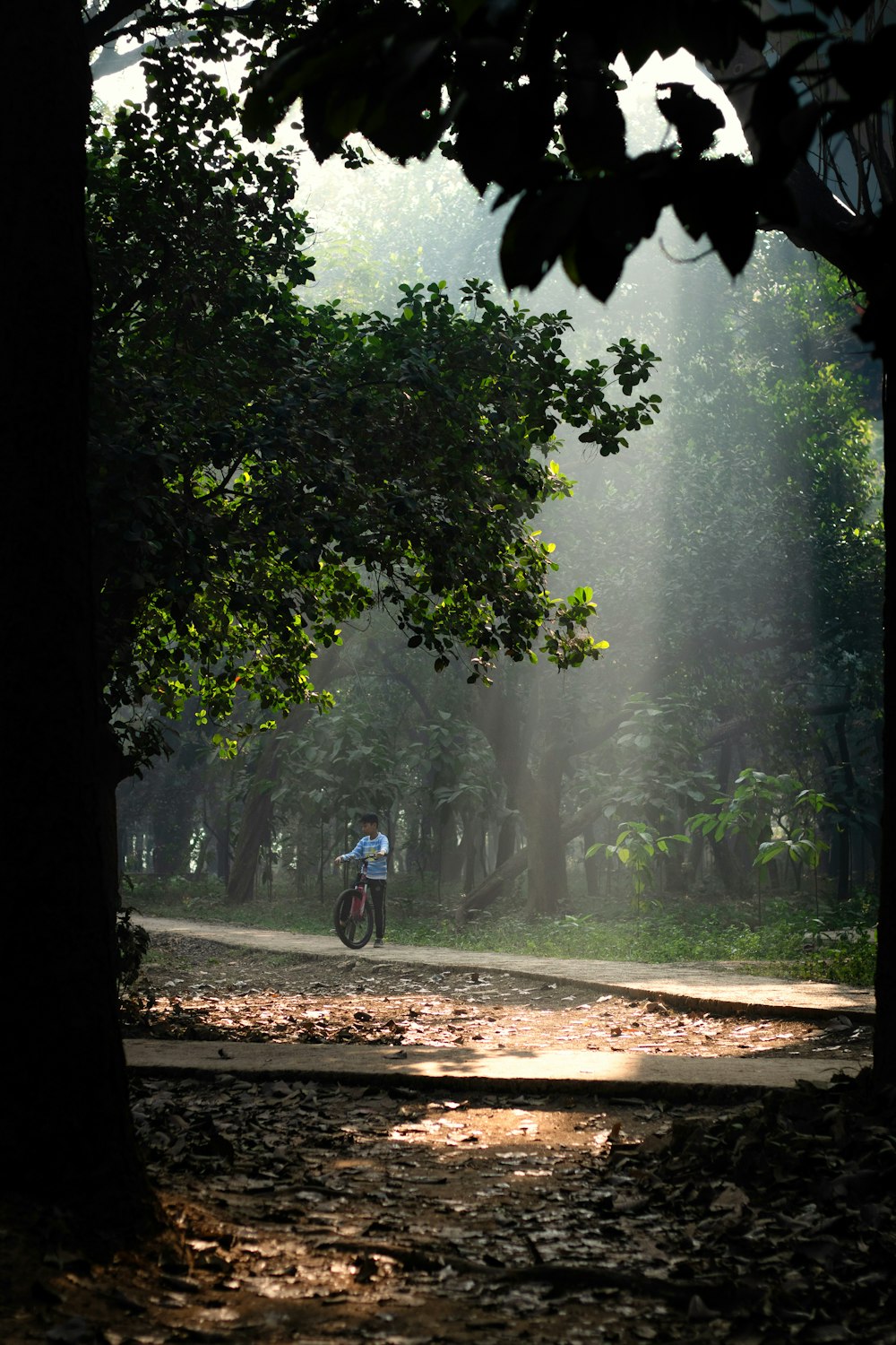 a man riding a motorcycle down a dirt road