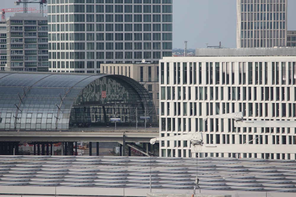 a train station in a city with tall buildings in the background