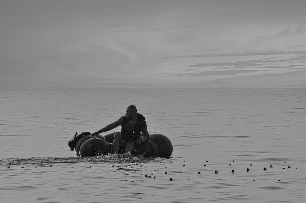 a man riding on the back of a boat on top of a body of water