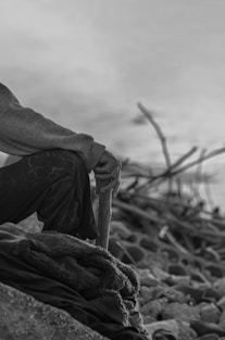 a man sitting on top of a pile of rocks