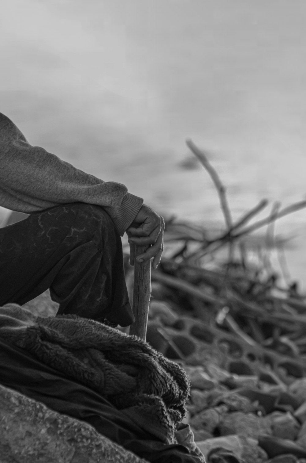 a man sitting on top of a pile of rocks