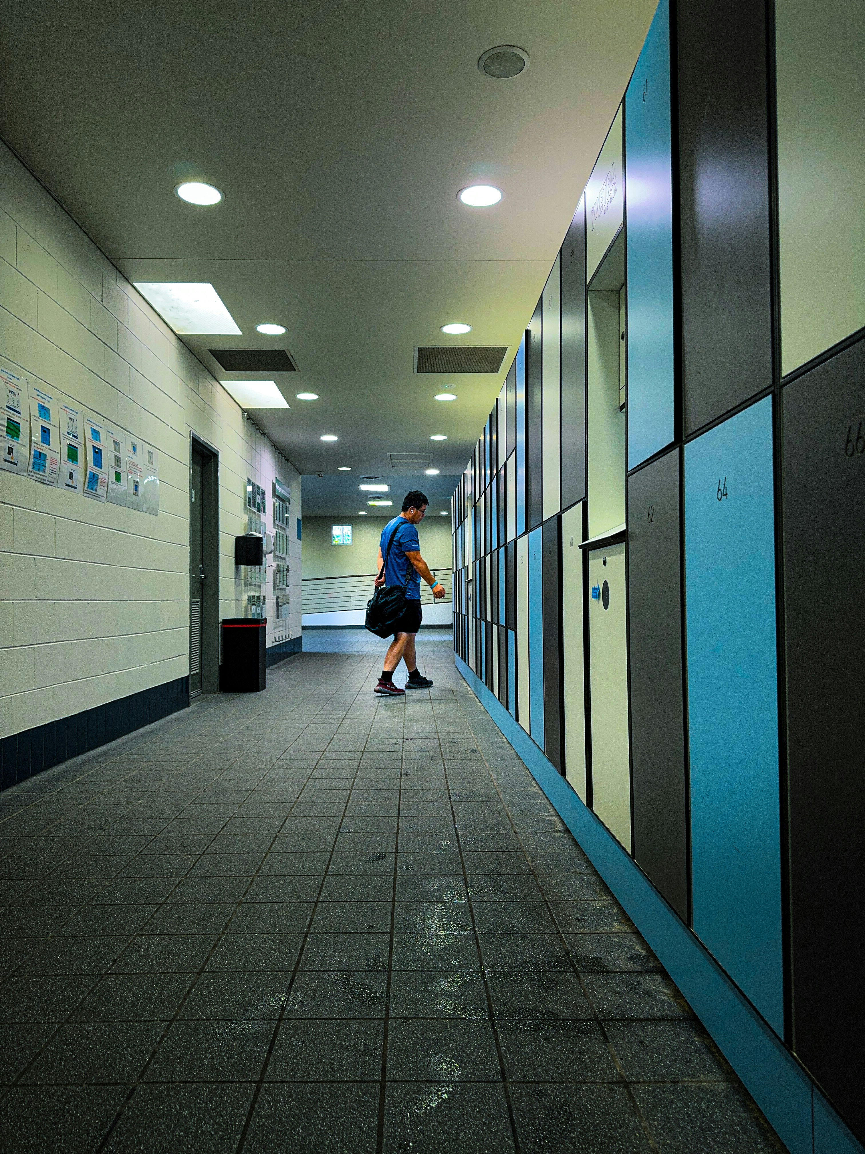 a person walking down a hallway in a building