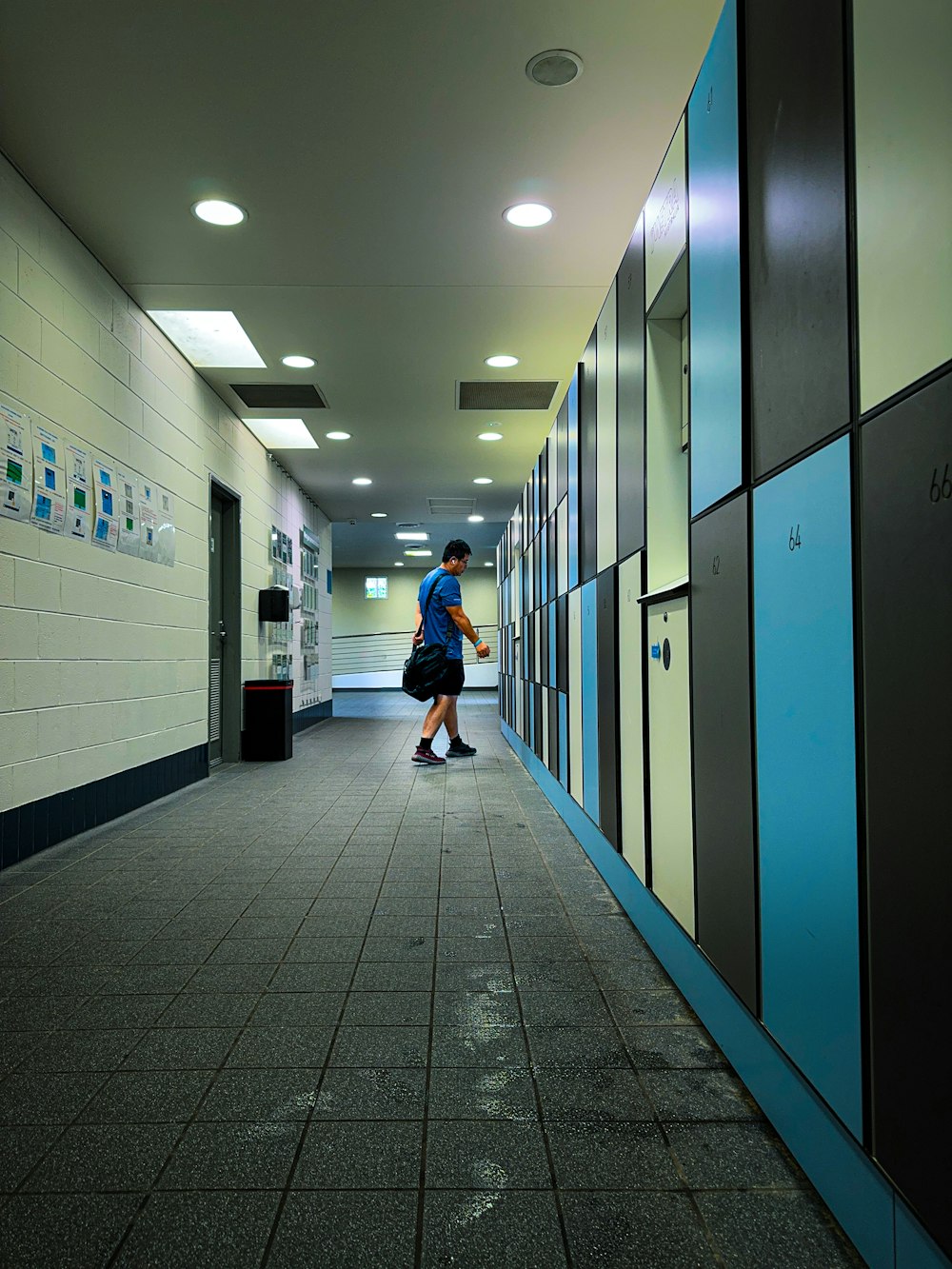 a person walking down a hallway in a building