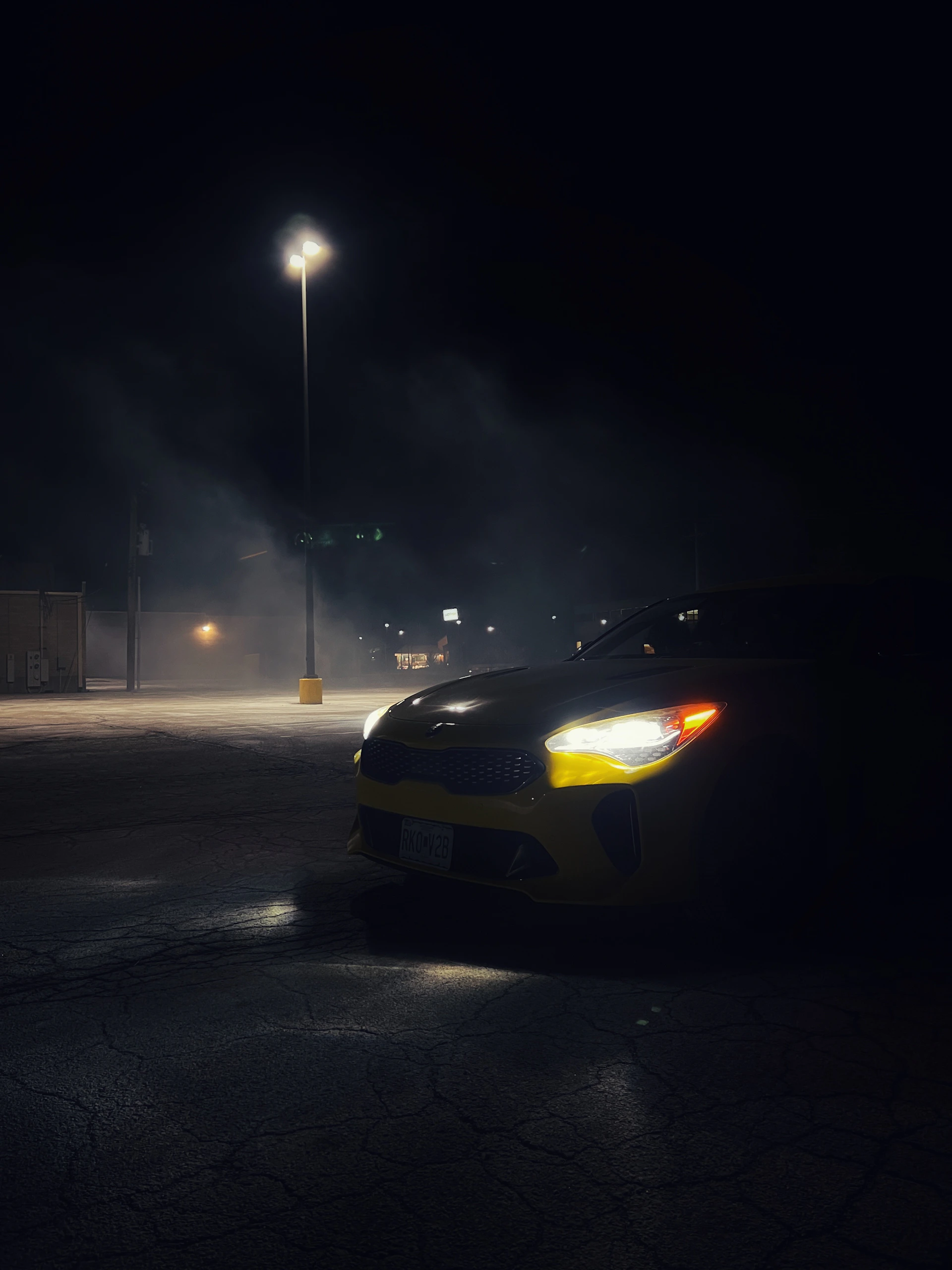 a car parked in a parking lot at night