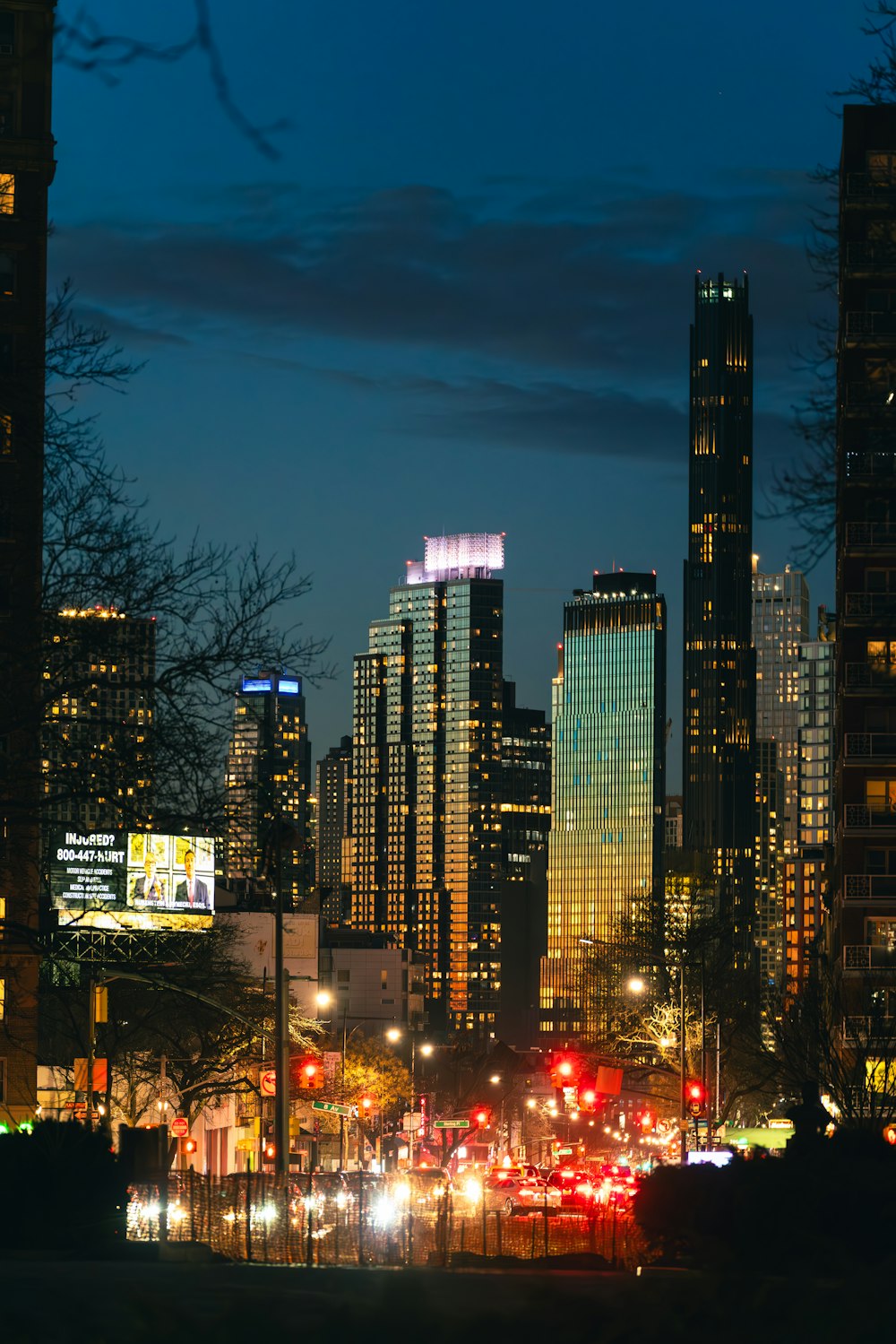 a city at night with tall buildings and street lights