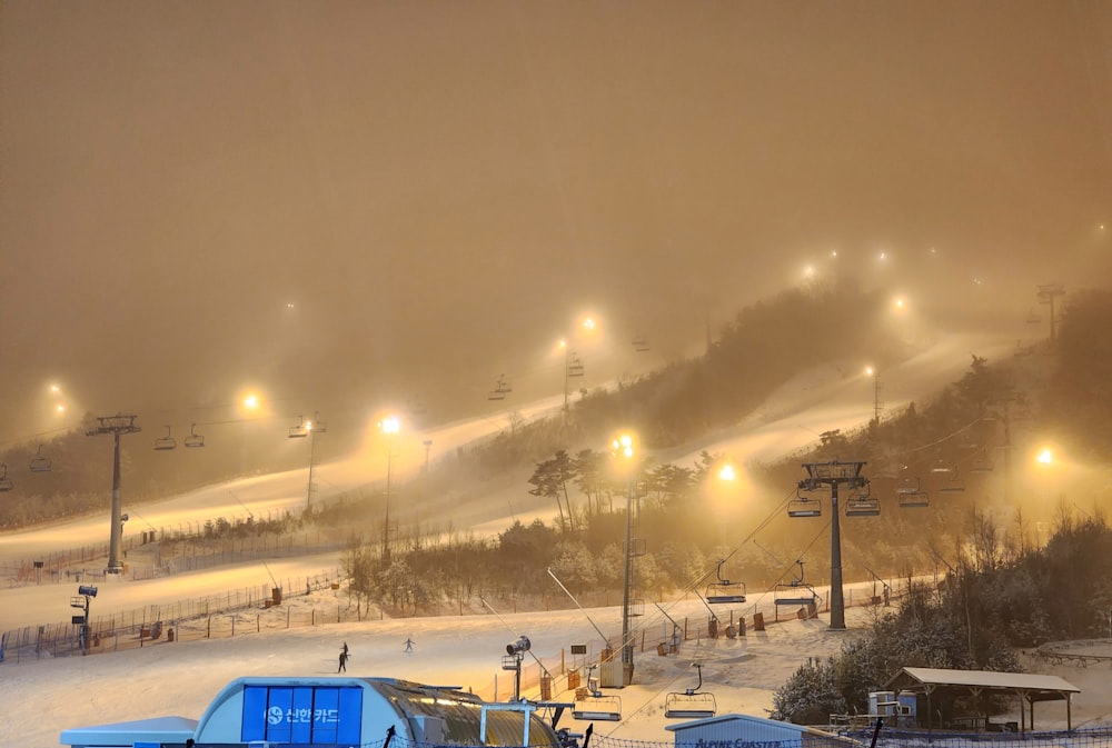 a ski slope covered in lots of snow at night