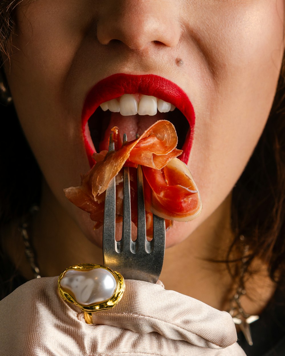 a woman holding a fork with food on it