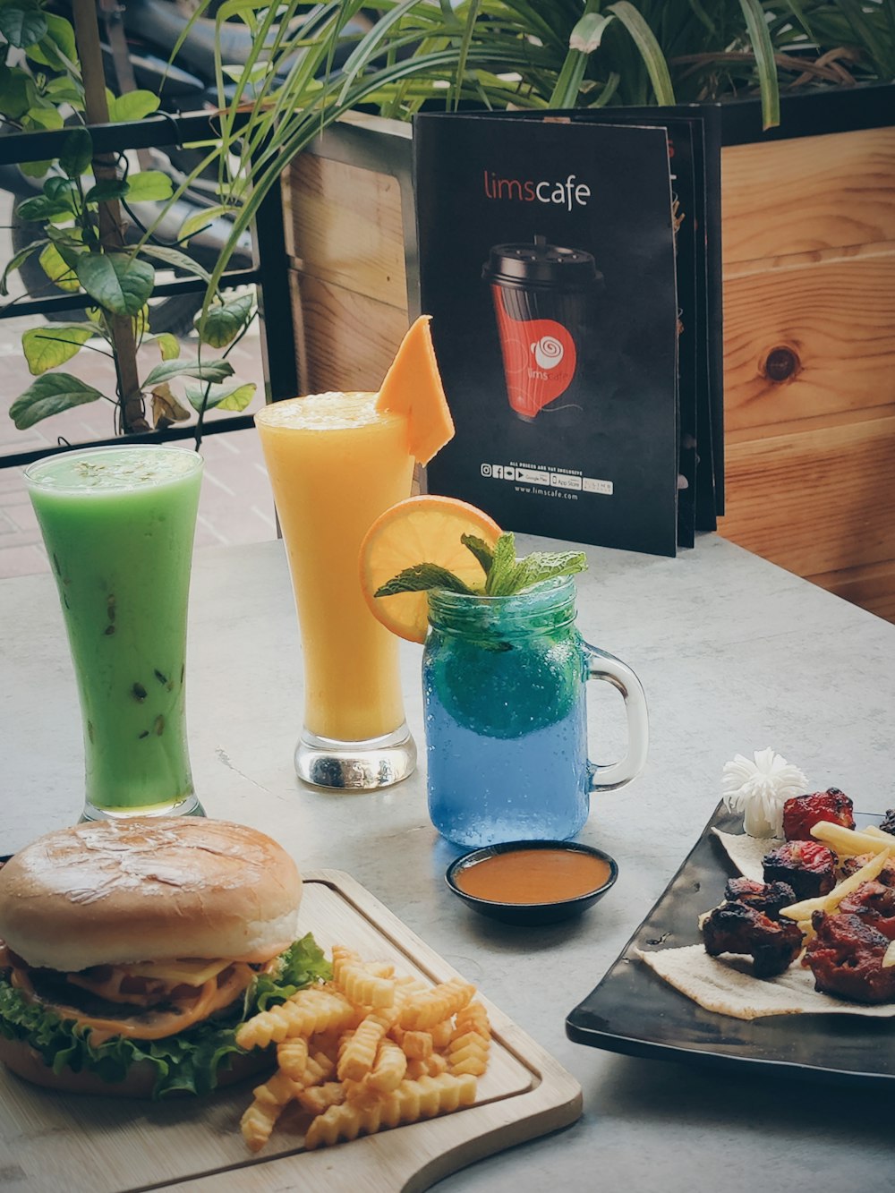 a table topped with plates of food and drinks