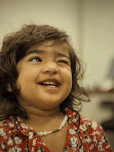 a little girl with a smile on her face