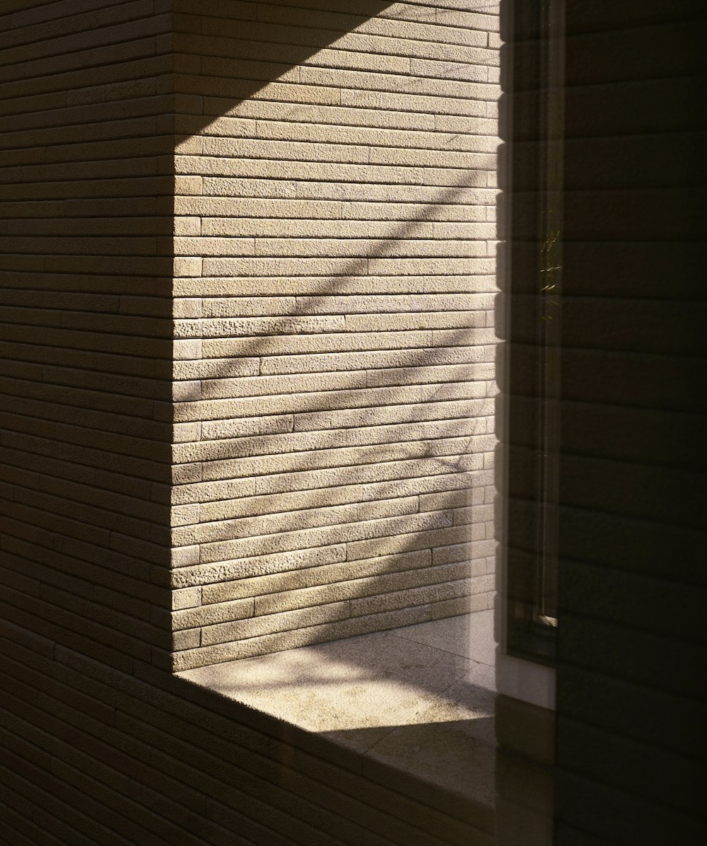 the shadow of a window on the side of a building