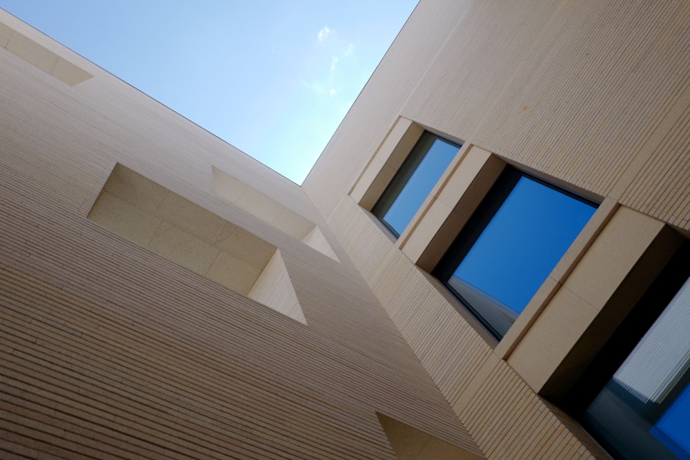 a building with three windows and a sky in the background