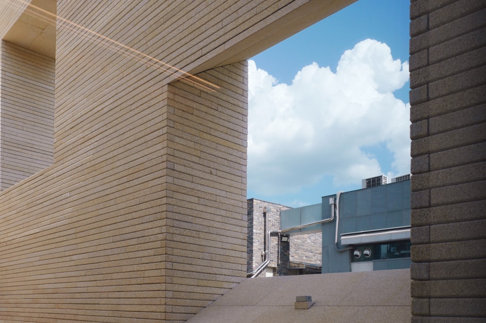 a view of a building through a gap in a wall