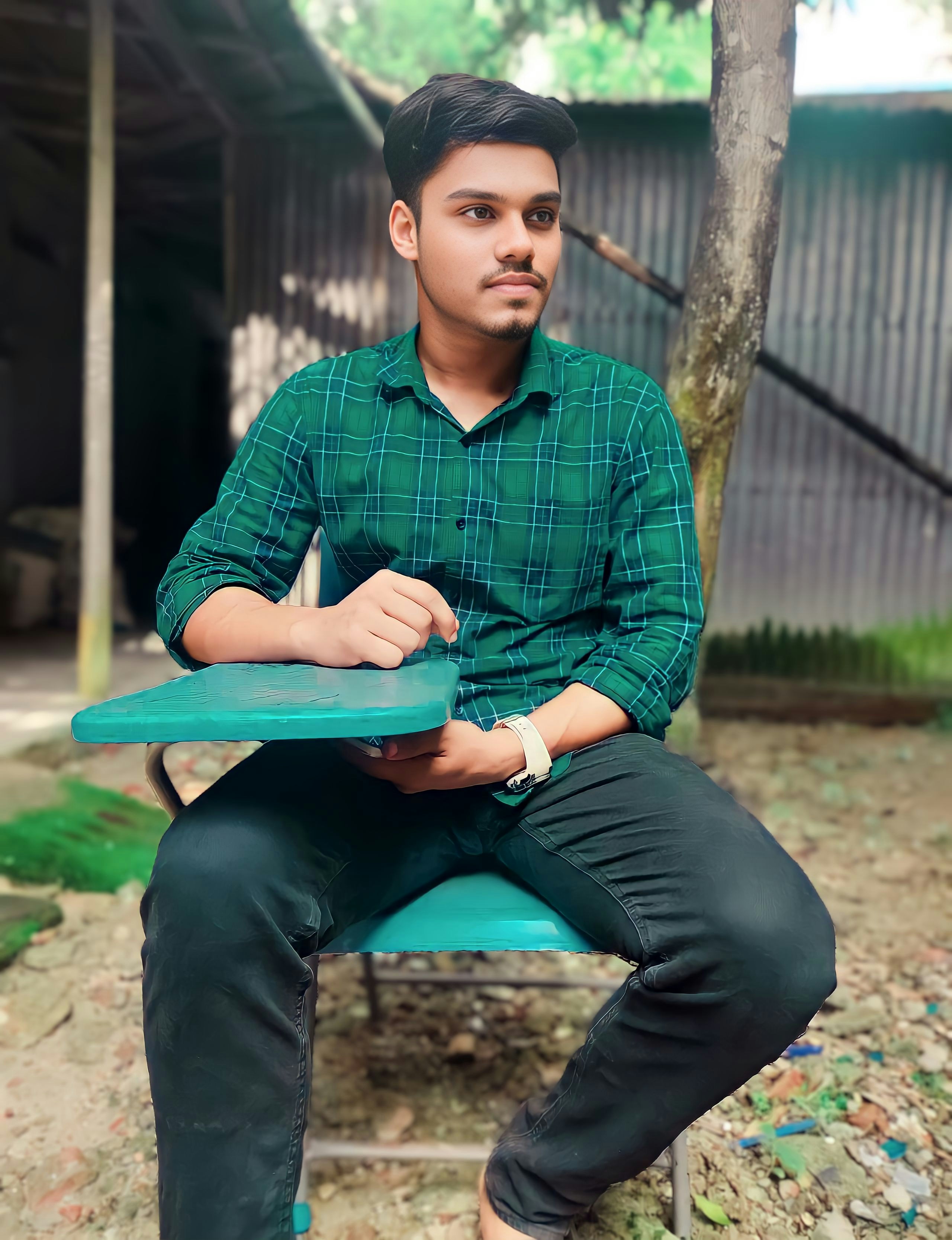 a man sitting on a bench in a green shirt