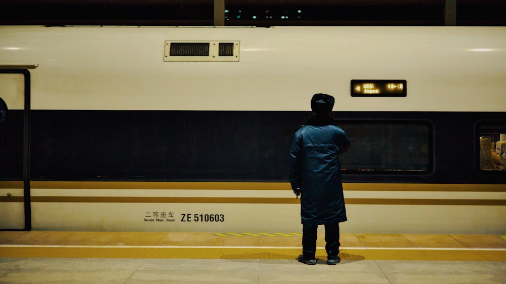 a person standing in front of a train