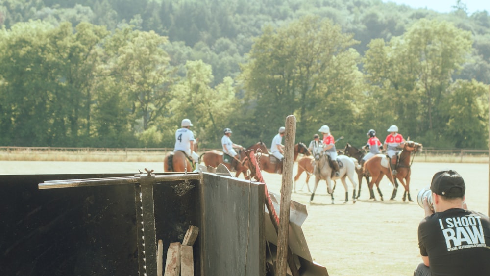 a group of people riding on the backs of horses