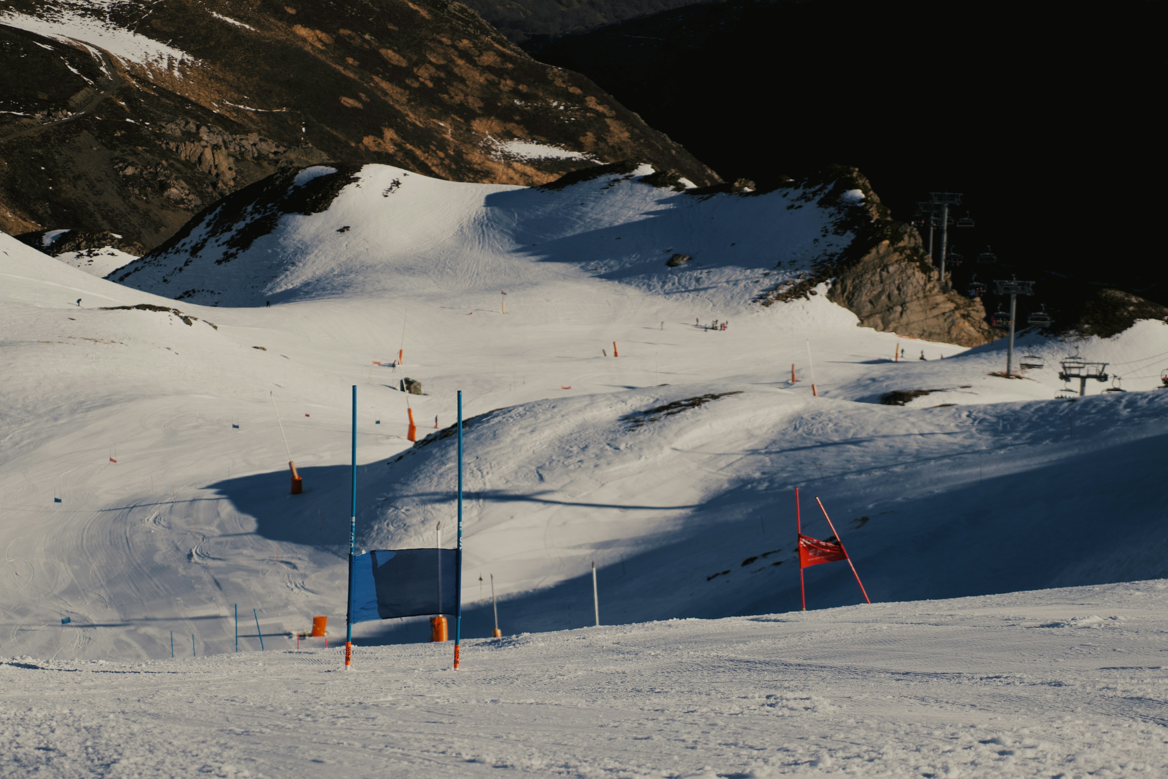 a snow covered ski slope with a mountain in the background
