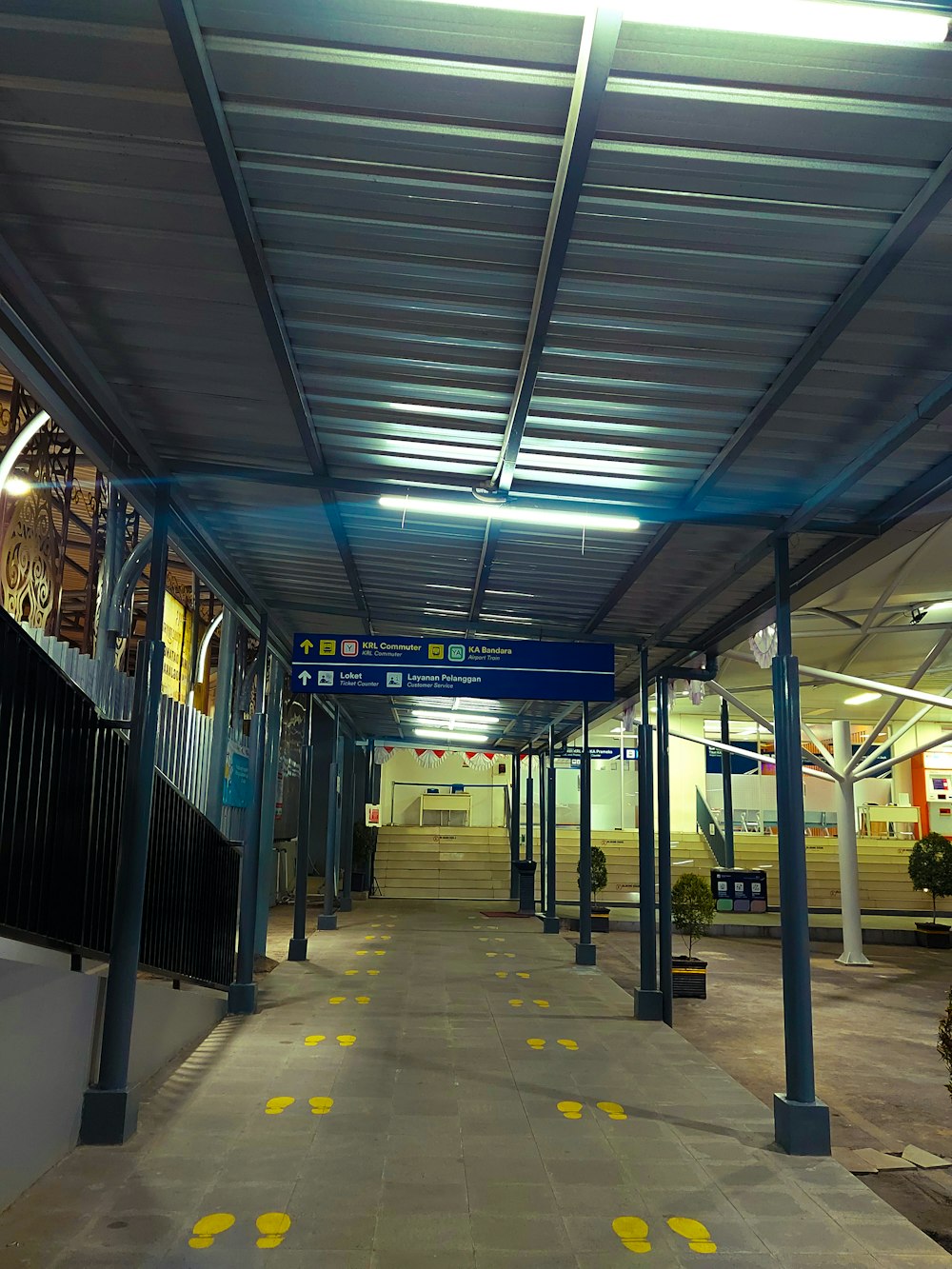 a long walkway with yellow markings on the ground