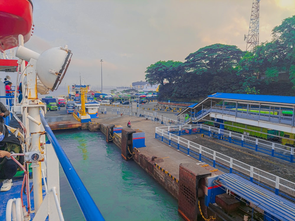 a man standing on the side of a boat next to a loading dock