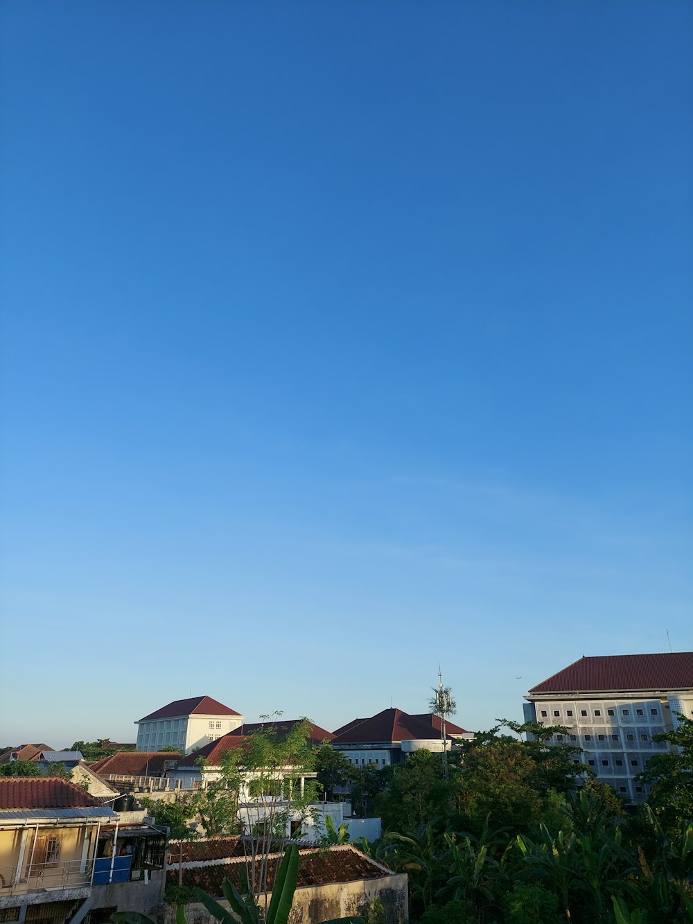 Ein klarer blauer Himmel mit ein paar Gebäuden im Hintergrund