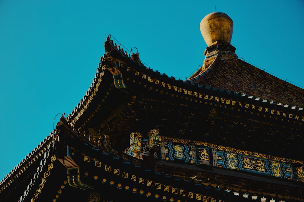 the top of a building with a blue sky in the background