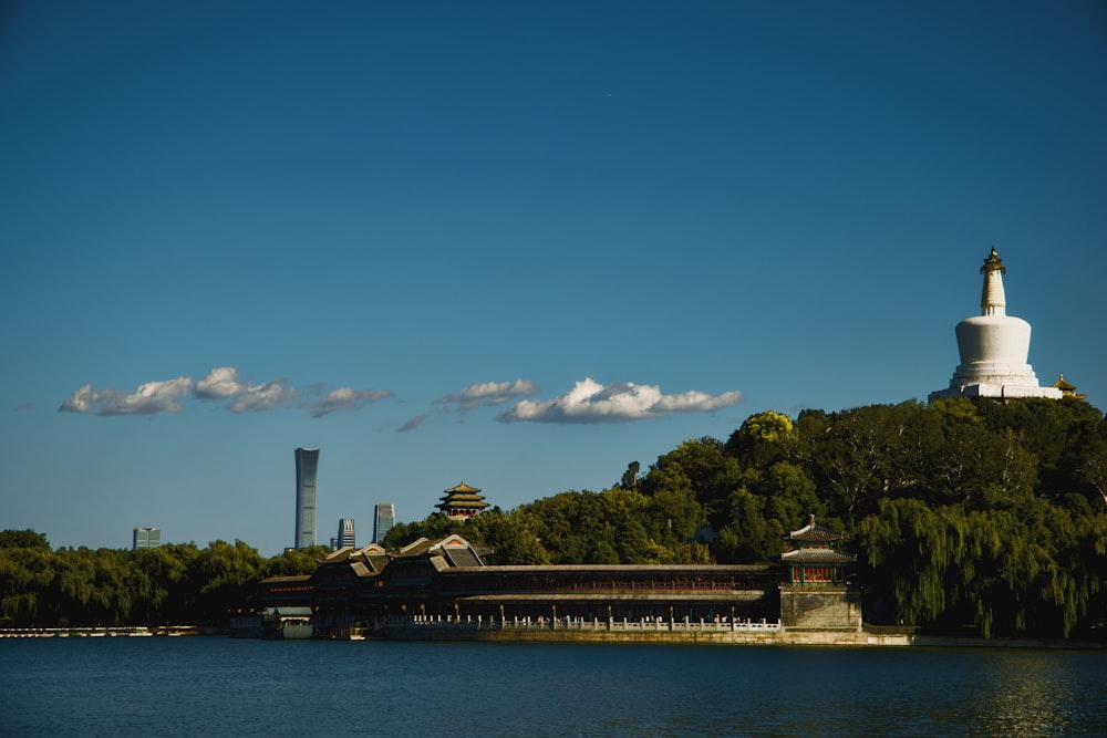 a body of water with a white building in the background