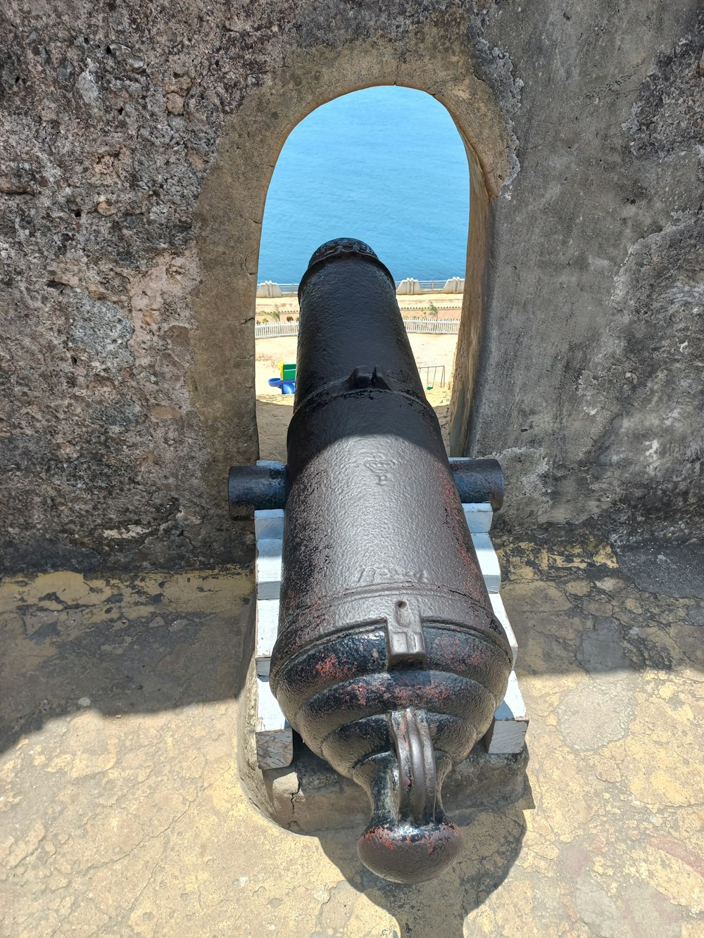 a cannon sitting on top of a stone wall