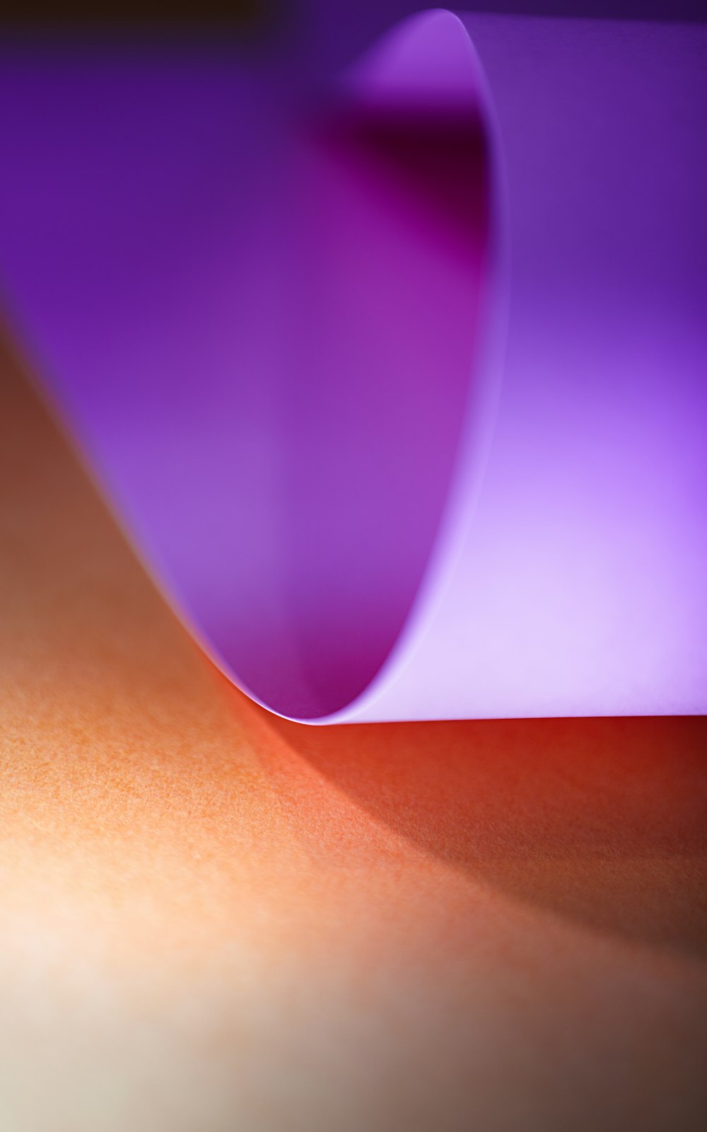 a close up of a purple vase on a table