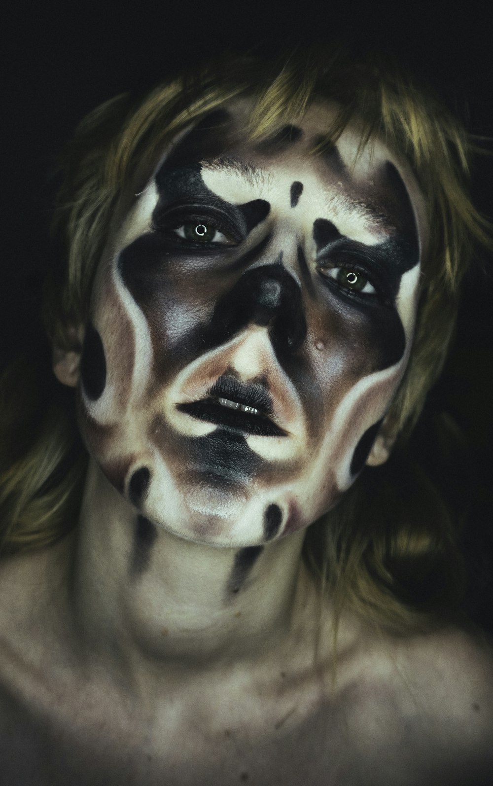 a woman with black and white makeup on her face
