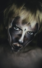 a woman with a face painted like a clown
