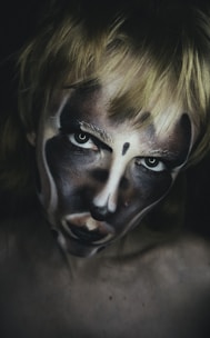 a woman with a face painted like a clown