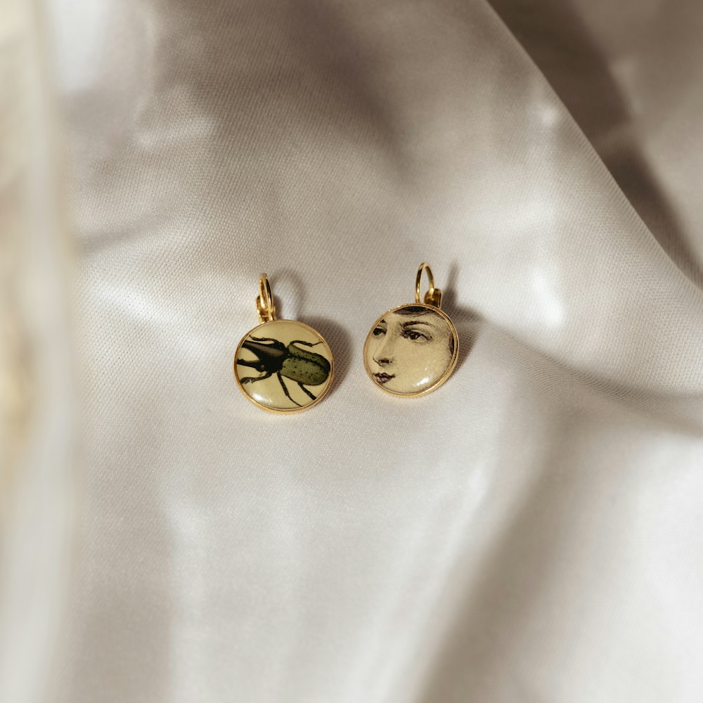 a pair of earrings with a picture of a woman's face