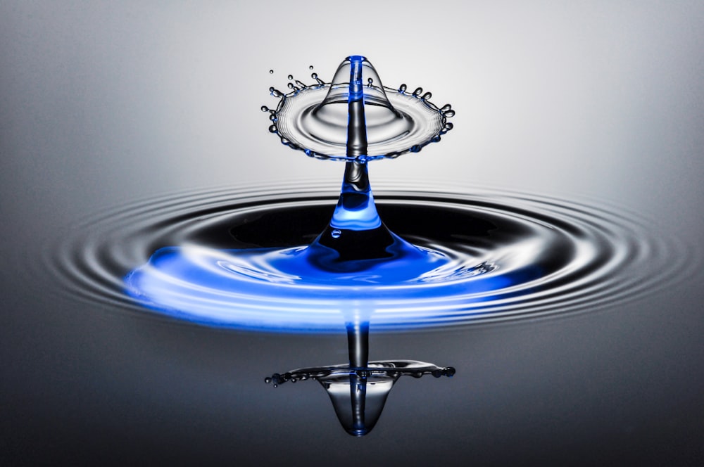 a water drop with a crown on top of it