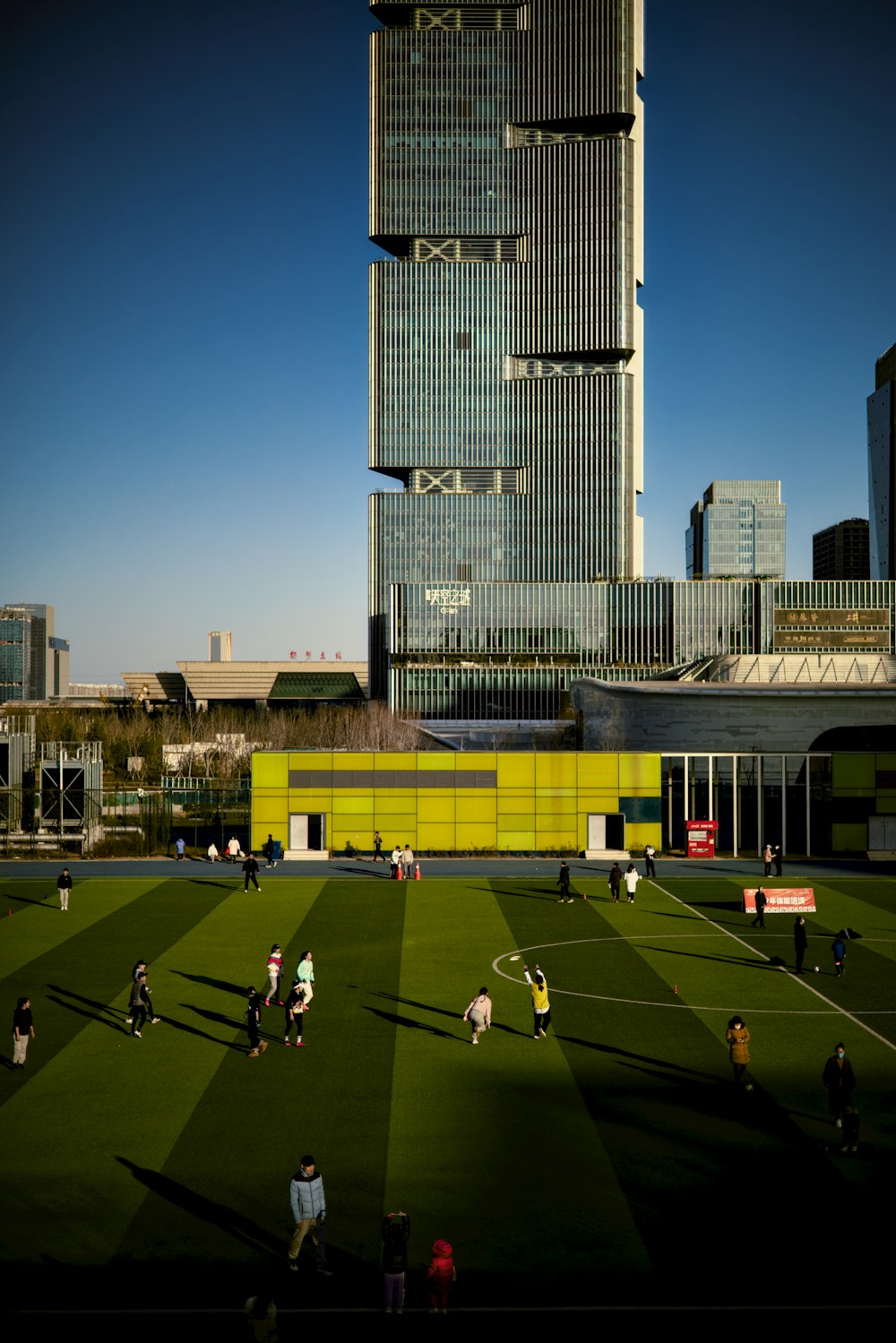 a soccer field in front of a tall building