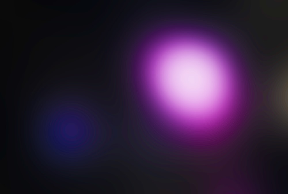 a blurry image of a black and purple background