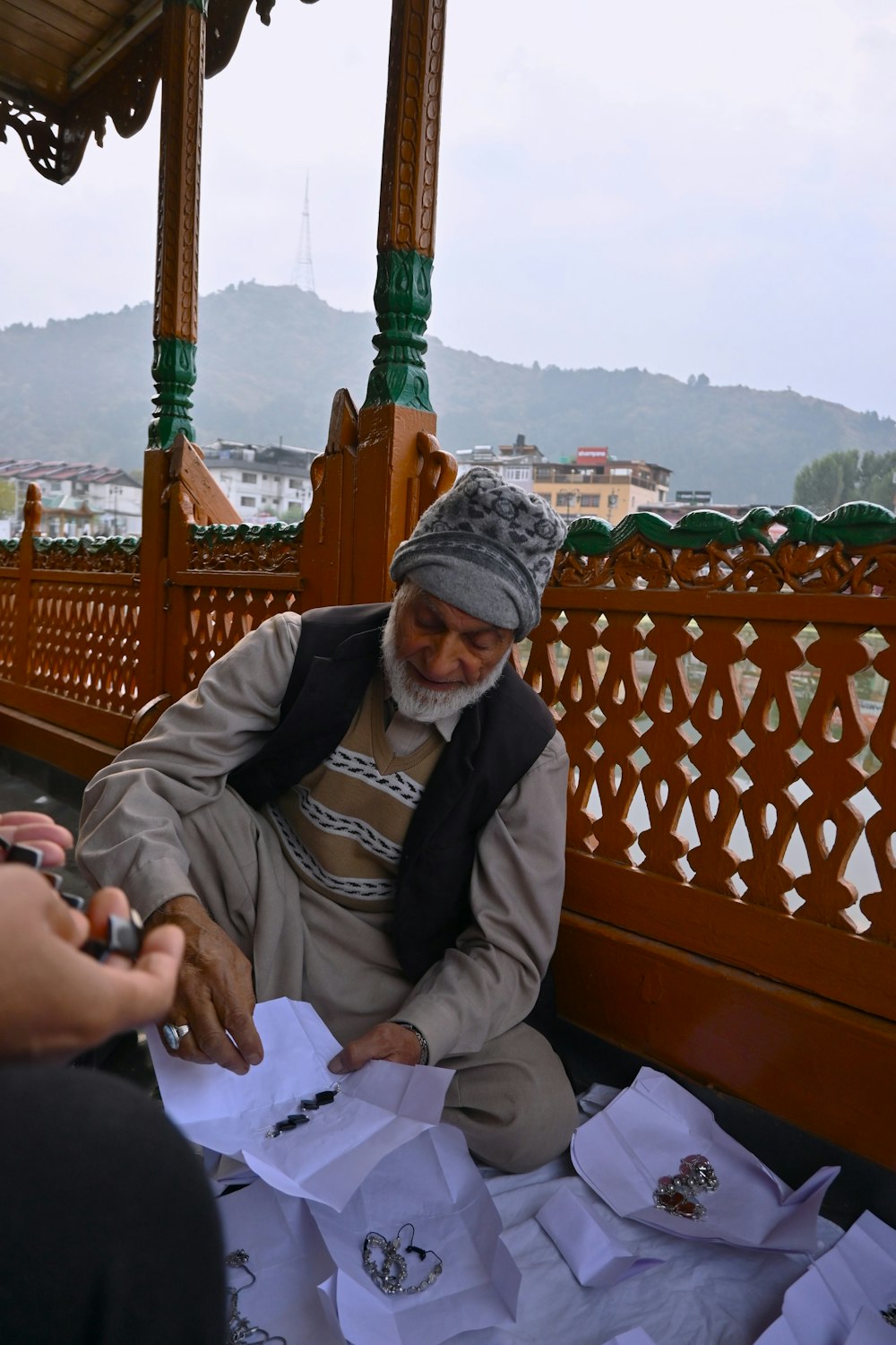 a man sitting on a bench holding a piece of paper